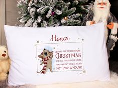 there is a christmas pillow with santa claus on it and a teddy bear next to it