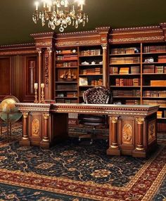 an ornate desk and chair sit in front of a bookcase with chandelier