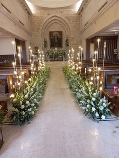 an aisle decorated with flowers and candles for a church wedding or special event in the uk