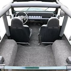 the inside of a car with seats and dashboards in grey carpeted flooring