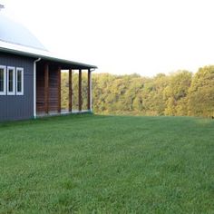 a house sitting on top of a lush green field