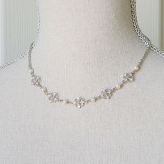 This necklace features beautiful rhinestones and ivory glass pearls . The necklace is reminiscent of the classic Regency designs of the past. It hangs about 16 1/4" long from a stainless steel chain with lobster clasp and 2" extender chain that are nickel free.   Comes in a lovely gift box with ribbon.  In the Eighteenth and Nineteenth centuries necklaces and earrings were very fashionable. Some were made of pearls, glass or gemstones and can be seen in many classic portraits. I think they're a Vintage Silver Bridal Necklace With Pearl Chain, Elegant Silver Rhinestone And Pearl Necklace, Victorian Pearl Charm Necklace For Wedding, Elegant Rhinestone Necklace For Vintage Events, Vintage Silver Pearl Bridal Necklace, Vintage Silver Bridal Necklace With Pearl Drop, Silver Pearl Rhinestone Necklace For Formal Occasions, Formal Silver Rhinestone Pearl Necklace, Formal Silver Pearl Rhinestone Necklace