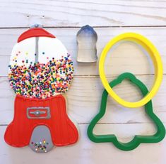 two cookie cutters, one with sprinkles on it and the other shaped like a snowman