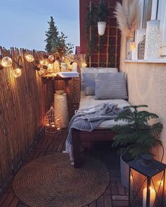 a small patio with lights and plants on it