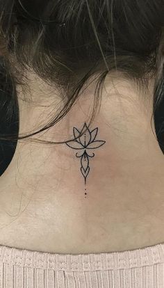 a woman's neck with a lotus tattoo on her left side ribcage