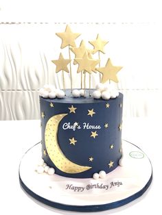 a birthday cake decorated with stars and the moon