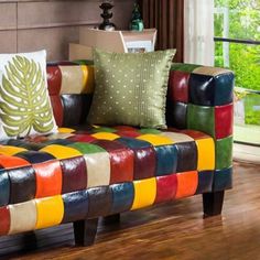 a colorful couch sitting on top of a hard wood floor