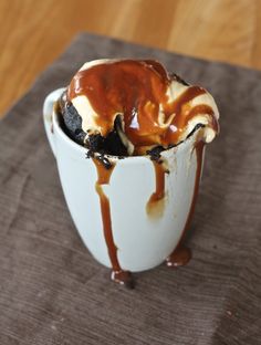 an ice cream sundae with caramel drizzle and chocolate sauce on top