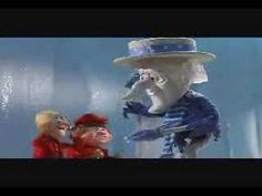 there is a white bear with a blue hat on and another person standing next to him