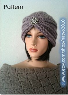 a mannequin head wearing a gray knitted hat with a flower on it