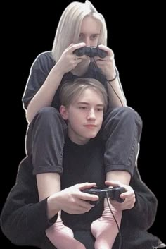 a woman sitting on top of a man holding a video game controller