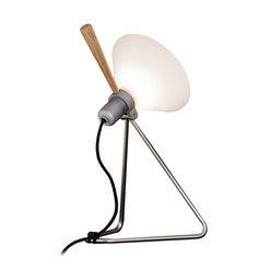 a lamp that is sitting on top of a metal stand with a wooden stick sticking out of it