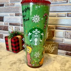 the starbucks cup has been decorated with christmas decorations