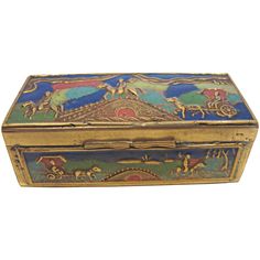 an ornately decorated gold and blue box with horses on the front, sitting against a white background