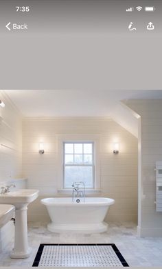 a white bathroom with a tub, sink and toilet