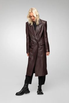 Women's Leather Trench Coat In Coffee Brown Indulge in timeless elegance with this women's leather trench coat in coffee brown. Crafted from genuine sheepskin leather with a semi-aniline finish, this long coat features a sophisticated notch collar and button closure. The stylish design is enhanced with zipper cuffs, offering a modern touch. Practicality meets luxury with one inside pocket and two side pockets. Perfect for any occasion, this coat adds a refined touch to your wardrobe. Outer Shell: Genuine Leather Leather Type: Sheepskin Leather Finish: Semi-aniline Feature: Long Coat Closure Style: Button Collar Style: Notch Cuffs Style: Zipper Inside Pockets: One Outside Pockets: Two Side Pocket Color: Coffee Brown Luxury Long Leather Coat, Luxury Designer Long Leather Coat, Luxury Long Leather Coat With Button Closure, Luxury Long Leather Jacket With Button Closure, Leather Trench Coat Woman, Leather Shorts Women, Short Leather Skirts, Leather Jumpsuit, Long Leather Coat