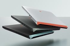 three laptops are stacked on top of each other