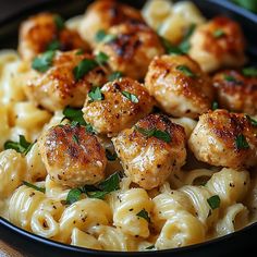 pasta with chicken and parsley in a black bowl