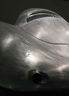 a large metal object is shown in the dark with light shining on it's side