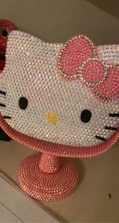 a hello kitty purse is sitting on top of a stand