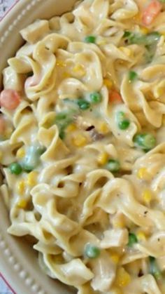 a bowl filled with pasta and peas on top of a table