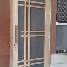 an open wooden door with metal bars on it