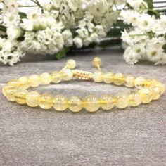 ✦Gemstone: Natural Citrine ✦Color: Yellow ✦Shape: Round  ✦Length: 5''-9'' ✦Bead Size: 6mm ✦QTY: 1 pc / package ✦✦Please measure your wrist size, then order the bracelet. Citrine Bracelet, Crystal Bracelet, Macrame Bracelet for Women, Valentine's Day Gift  Citrine is also known as the Merchant's Stone, due to its ability to transmute energies quickly and easily, facilitating transfers of energy from one to another. For those involved in business ventures, particularly new business ventures with new clients or partners, Citrine can be an excellent tool to have on hand, whether in one's pocket or purse, to increase the flow of money-based energy from one hand to another. One can place the stone in parts of one's house where the money is kept to safeguard it and keep its energetic qualities pu Crystal Macrame, Energy Yoga, Bracelet Macrame, Yellow Bracelet, Citrine Bracelet, Bracelet Crystal, Macrame Bracelet, Natural Citrine, Macrame Bracelets