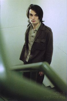 a young man standing in front of a mirror