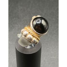 Sterling And Gold Ring Size 7 Silver With Gold Accents And Black Onyx Stone Beautiful ring, excellent condition Measures a size 7 Features: * ring Size: Womens 7 Condition: Pre-Owned Good Classic Black Cabochon Rings, Vintage Black Gemstone Rings, Vintage Onyx Black Rings, Vintage Black Ring With Polished Finish, Black Vintage Ring With Polished Finish, Formal Black Cabochon Rings, Collectible Black Rings With Polished Finish, Vintage Black Round Rings, Vintage Black Collectible Rings