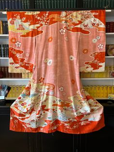 "Exceptional colours on this early 1900s silk kimono. These hand dyed long sleeved kimonos were worn by unmarried women for formal occasions.  Called 'Furisode' Yuzen dyed fine silk crepe with embroidery and traditional Japanese flower motifs. It is in excellent condition.  The traditional kimono was hand stitched and unstitched for laundering then re-tacked for storage.   This kimono is hand tacked.  It can be displayed this way but if you wish to wear it you would need to machine stitch it. On Traditional Pink Silk Kimono, Pink Vintage Long Kimono, Vintage Silk Kimono For Wedding, Traditional Long Orange Kimono, Ceremonial Vintage Kimono, Vintage Multicolor Silk Kimono, Vintage Red Kimono For Tea Ceremony, Traditional Orange Long Sleeve Kimono, Vintage Long Sleeve Wedding Kimono