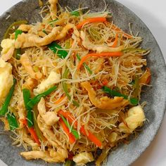 a plate full of stir fried vegetables and noodles