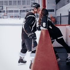 two people are kissing on the ice rink