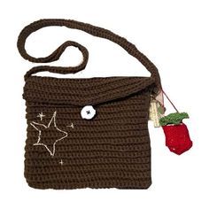 a crocheted brown bag with a star on the side and a red christmas ornament hanging from it