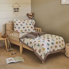 a bedroom with a bed, book and toys on the floor