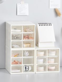 a white desk with many drawers on it