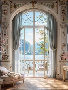 an open door leading to a balcony with a view of the water and mountains in the distance