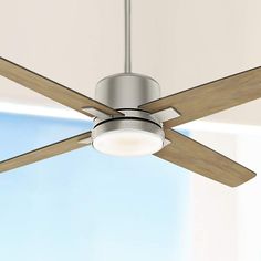 a ceiling fan that is mounted on the wall with a light fixture in front of it