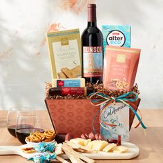 a wine bottle and some snacks on a table