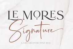 the signature font and script for le mores signature is laid out on a bed