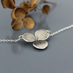 Hydrangea Blossom Necklace  Sterling Silver Flower by lisahopkins, $58.00 Delicate Sterling Silver Petal Jewelry, Delicate Silver Flower Necklace With Birth Flower, Minimalist Sterling Silver Flower Shaped Necklaces, Delicate Silver Birth Flower Necklace, Minimalist Sterling Silver Flower Necklace, Delicate Silver Petal-shaped Jewelry, Silver Delicate Petal-shaped Jewelry, Delicate Petal-shaped Jewelry With Flower Charm, Hydrangea Ring