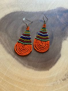 These handmade beaded earrings are truly unique. Each one is hand made with a rotating striped pattern. These earrings are available in a multitude of colors -making them perfect for any outfit! Whether it's dressing up a jean jacket or adding a unique texture to a LBD, there's no way you can go wrong with these earrings! We have given each design a name in honor of our favorite people! Please note that colors may vary a bit by pair as no two are exactly alike Handmade Casual Beaded Earrings, Casual Handmade Beaded Earrings, Multicolor Teardrop Casual Jewelry, Casual Multicolor Teardrop Jewelry, Casual Multicolor Earrings For Festivals, Casual Multicolor Beaded Earrings, Casual Multicolor Festival Earrings, Casual Multicolor Dangle Beaded Earrings, Casual Multicolor Beaded Dangle Earrings