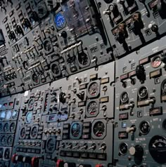 the control panel in an airplane is full of buttons and dials for pilots to use