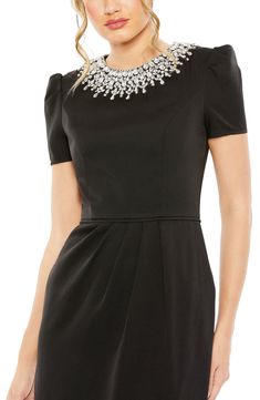 A dazzlingly embellished neckline shakes up the prim and proper aesthetic of a sheath-style midi shaped with tailored waist pleats and softly puffed shoulders. 45" length Hidden back-zip closure Jewel neck Short sleeves Back slit Partially lined 100% polyester Spot clean Imported Asian Owned/Founded Black Dress With Rhinestones, Short Wedding Guest Dresses, Short Sleeve Black Dress, Champagne Formal Dresses, Modest Formal Dresses, Dress With Rhinestones, Light Blue Prom Dress, Sage Green Bridesmaid Dress, Sleeve Black Dress