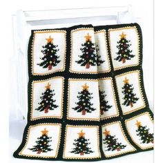 a crocheted christmas tree afghan is displayed