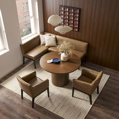 a living room with couches, chairs and a round table in the middle of it