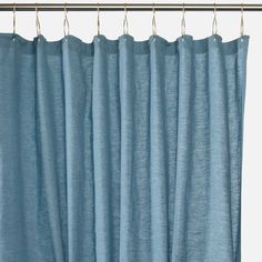 a blue curtain hanging from a metal rod