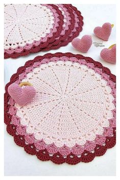 two crocheted doily with hearts on them