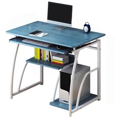 a computer desk with a laptop on top of it next to a stack of books