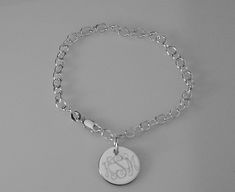 "This lovely sterling silver bracelet features a 17 gauge, high polish sterling silver 1/2\" diameter disc on a sterling silver 7\" chain, with a lobster claw clasp. I can engrave a monogram, one to three initials, or a name, date or word up to 10 characters. The back of the disc can also be engraved with up to 10 characters The bracelet will be delivered to you in a gift box. This style is also available in 8\" Length: https://www.etsy.com/listing/950524673/custom-engraved-monogram-or-initial? Classic Sterling Silver Charm Bracelet With Silver Chain, Classic Engraved Sterling Silver Charm Bracelet, Classic Round Charm Bracelet With Polished Finish, Engraved White Gold Sterling Silver Bracelet, Hallmarked White Gold Chain Bracelet, Hallmarked White Gold Round Chain Bracelet, Personalized Sterling Silver Jewelry With Oval Link, Personalized Sterling Silver Oval Link Jewelry, Classic Sterling Silver Charm Bracelet Hallmarked