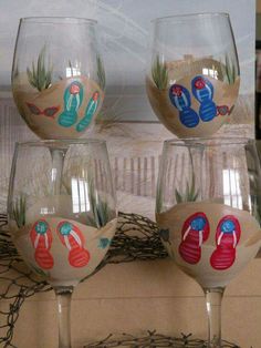 four wine glasses with different designs on them